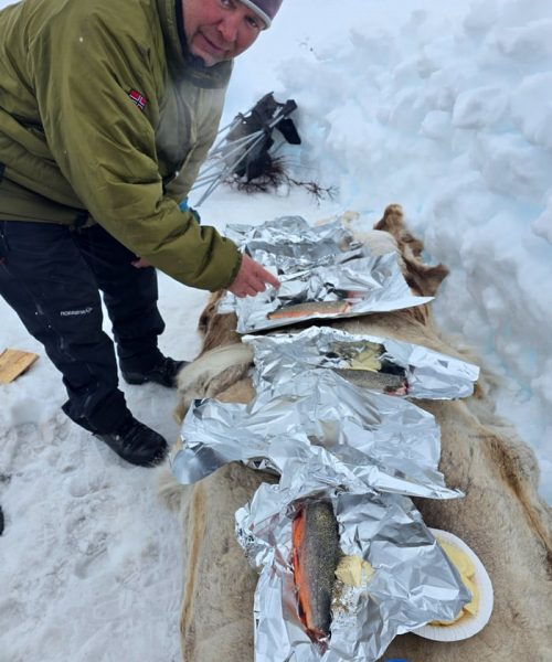 Preparing fresh fish on the ice for barbeque