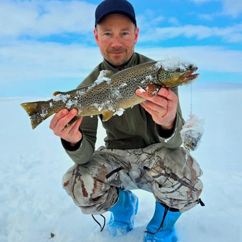 Male tourist ice fishing