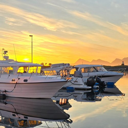 Boat in habor with midnight sun